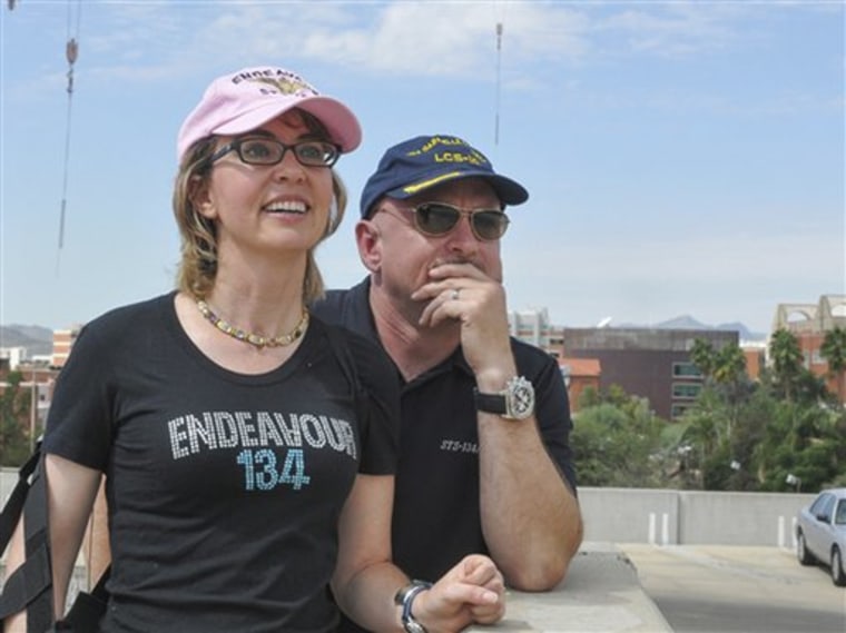 In this photo provided by the Southwest Photo Bank, former U.S. Rep. Gabrielle Giffords and husband, former astronaut Mark Kelly, watch the Space Shuttle Endeavor fly over Tucson, Ariz. on its way to Los Angeles, Thursday, Sept. 20, 2012. Kelly, Endeavour's last commander, requested that the shuttle pass over Tucson to honor Giffords, who is recovering after suffering a head wound in a shooting rampage last year. (AP Photo/Southwest Photo Bank, P.K. Weis) MANDATORY CREDIT